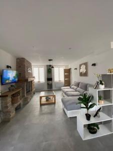 a living room with a couch and a tv at L havre de paix in Avelin