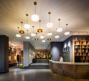 a lobby of a library with pendant lights at Rila Hotel Sofia in Sofia