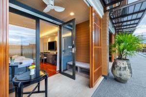 a house with a glass door leading to a bedroom at Treepana Boutique Hotel, Huahin in Hua Hin
