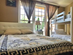 a bedroom with two beds and a large window at Happy vacation home by Erie lake in Kingsville