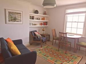 uma sala de estar com um sofá, cadeiras e uma mesa em Relax and enjoy the sea view em Kent