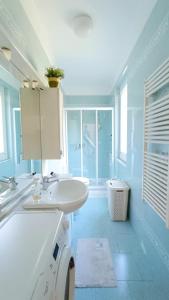 a white bathroom with a sink and a toilet at Villa Mortola in Camogli