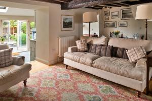 a living room with a couch and a rug at Finest Retreats - Hen Dafarn in Conwy