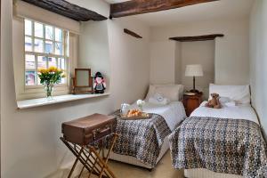 a bedroom with two twin beds and a window at Finest Retreats - Hen Dafarn in Conwy