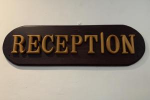 a sign that says receptorion hanging on a wall at Ketapang Residence Powered Nature in Jakarta