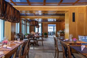a dining room with wooden tables and chairs at Appenzeller Huus Löwen in Gonten