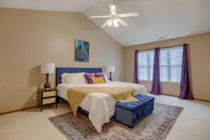 a bedroom with a large bed and a blue ottoman at Cozy Winter Retreat with Modern Minimalist Charm in Omaha