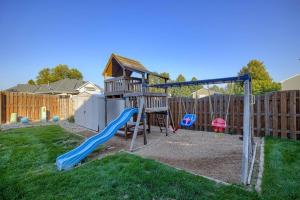 a playground with a slide and a play house at Cozy Winter Retreat with Modern Minimalist Charm in Omaha