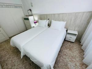 a large white bed in a hotel room at Las Vistas Beach Los Cristianos 2 Swimming Pools in Los Cristianos