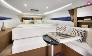 a master bedroom with a bed and a couch at SuiteOnBoat in Naples