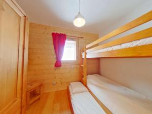 a bedroom with two bunk beds and a window at Appartement Villard-sur-Doron, 4 pièces, 7 personnes - FR-1-594-53 in Villard-sur-Doron