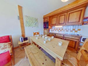 a kitchen with a wooden table with cups on it at Appartement 3 pièces avec piscine, proche centre Les Saisies, 5 pers, parking, balcon, classé 3 étoiles - FR-1-594-98 in Villard-sur-Doron