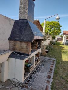 a house with a stove with a roof at Departamento "Juana"para 4 personas 2 cuartos con garage en Santa Teresita in Santa Teresita