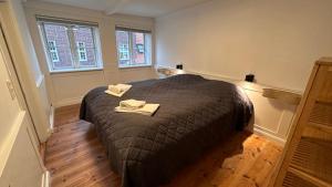 a bedroom with a bed with two towels on it at Boutique Apartments 1 - 8 in Copenhagen