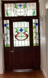 a wooden door with stained glass windows on it at Gardens Retreat in Cape Town