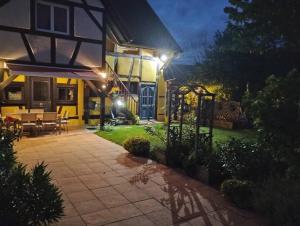a house with a patio at night with lights at Gîte Alsace in Appenwihr