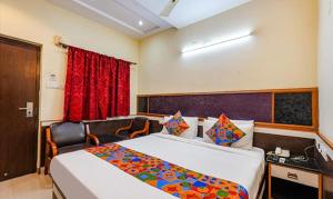 Habitación de hotel con cama grande y escritorio. en FabHotel Sairam Residency, en Bangalore