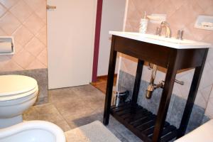 a bathroom with a sink and a toilet at Apartment Dr.Romulo Naon in Buenos Aires +13 photos
