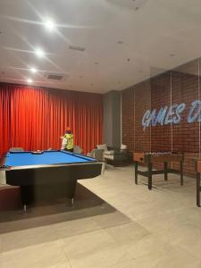 a man standing in a room with a pool table at Sky Trees Nflix Make Up Table with Pool & Facilities in Johor Bahru