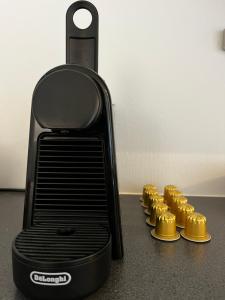 a row of gold muffins sitting next to a blender at North Estate Kræmervegen in Tromsø +2 photos