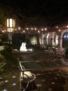 a courtyard at night with a fountain and lights at Fortin de Santa Rosa in Atlántida