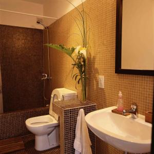 a bathroom with a toilet and a sink at Hostel Carlos Gardel in Buenos Aires