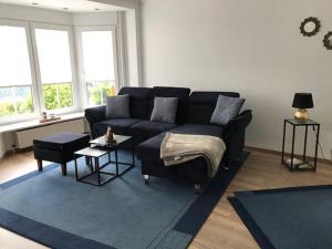 a living room with a couch and a blue rug at Ferienwohnung Wellenkamp in Itzehoe