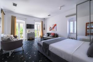 a bedroom with a large bed and a living room at Blue Sky House in Pylos