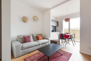 a living room with a couch and a table at Amazing & Central Milan Apt - City Life District! in Milan