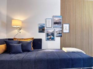 um quarto com uma cama azul com fotografias na parede em Appartio: Geräumige, moderne Ferienwohnung für Gruppen/Familien em Estugarda