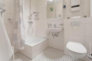 a white bathroom with a toilet and a sink at Kammerweg 5, Nordlicht in Scharbeutz
