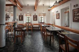 a restaurant with tables and chairs in a room at Hotel Javor in Adršpach