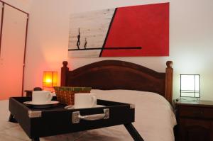 a bed with a tray with two cups on it at Apartment Dr.Romulo Naon in Buenos Aires