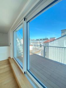 a balcony with a large sliding glass door at Home Sweet Home Vienna - Penthouse in Vienna