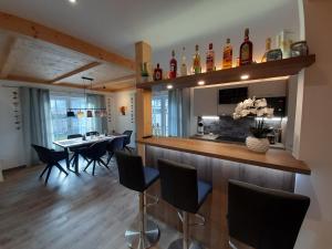 a kitchen and dining room with a bar and chairs at Hochalmbahnen Chalets Rauris 1-01 Maislaufeldweg 1a in Rauris