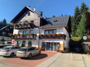 um edifício com carros estacionados em frente em King size apartmán Pension Monika em Spindleruv Mlyn