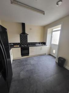 a kitchen with a stove top oven in a room at The Dublin Packet Apartment in Holyhead