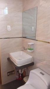 a bathroom with a sink and a toilet at Confortable habitación doble frente al Aeropuerto in Lima