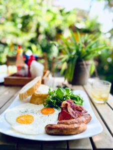 een bord eieren en spek en toast op een tafel bij Uyen's House in Con Dao