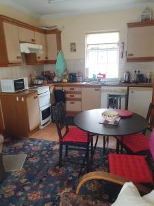 a kitchen with a table and chairs in it at Lily's Place - up to 4 persons in Birr