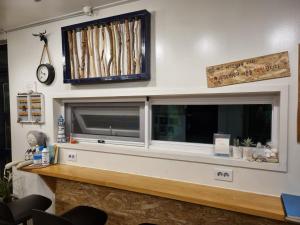 a flat screen tv on a wall with a window at Sokcho Hutte in Sokcho