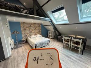 a bedroom with an art sign in a room at gites des cigognes in Dunkerque