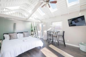a white bedroom with a bed and a table at 4221 Urban oasis in Hillcrest Mission Hills in San Diego