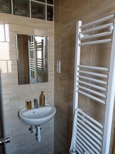 a bathroom with a sink and a mirror at Villa Fonyód in Fonyód