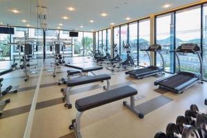 a gym with a bunch of treadmills and machines at Hua hin The Trust condo by Wila in Hua Hin