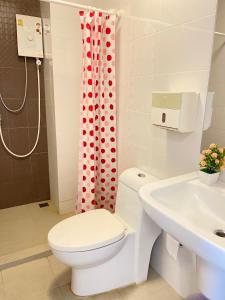 a bathroom with a toilet and a shower curtain at Hua hin The Trust condo by Wila in Hua Hin