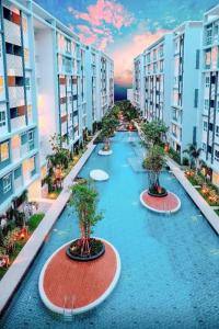 a row of buildings with trees in the middle at Hua hin The Trust condo by Wila in Hua Hin