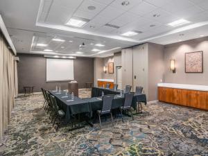 a conference room with a table and chairs and a screen at Residence Inn Phoenix Glendale Sports & Entertainment District in Glendale