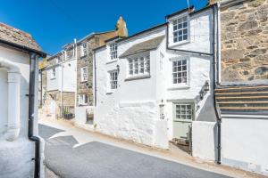 a row of white houses on a street at Mariners Cottage, St Ives in St Ives