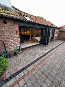 an extension to a brick house with a patio at The stables at the Grange in York